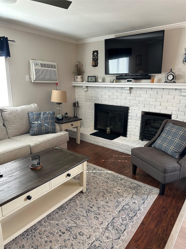 living area featuring crown molding, a brick fireplace, wood finished floors, and a wall mounted air conditioner