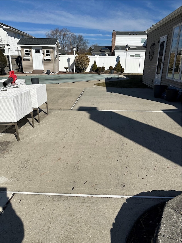 exterior space with a patio, an outdoor structure, and fence