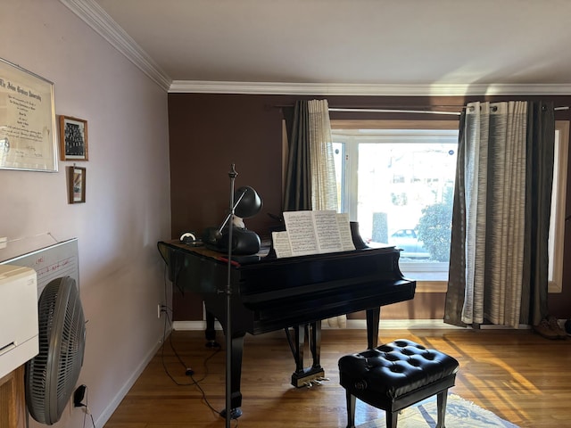 sitting room with crown molding, baseboards, and wood finished floors