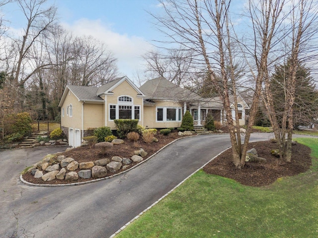 view of front of house with aphalt driveway and an attached garage