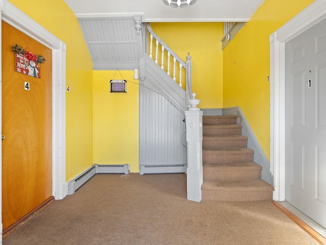 stairs featuring a baseboard radiator and carpet flooring