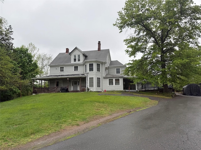 64 Rosman Rd, Thiells, NY 10984 - victorian home featuring a porch, a front yard, and a chimney