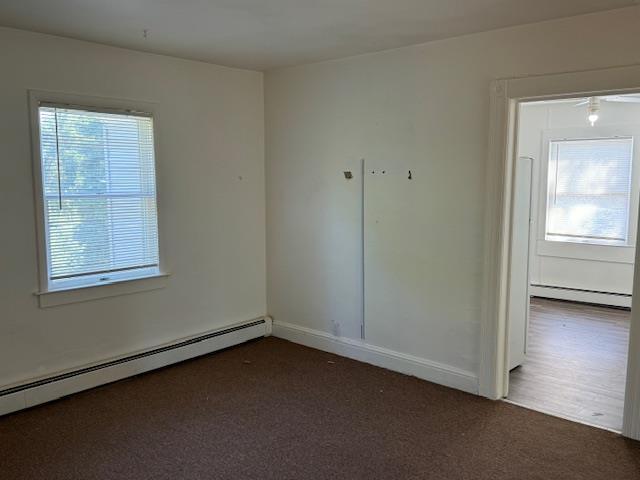 64 Rosman Rd, Thiells, NY 10984 - carpeted empty room featuring baseboard heating