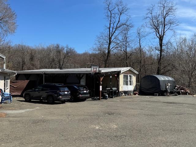 64 Rosman Rd, Thiells, NY 10984 - view of parking / parking lot with an attached carport