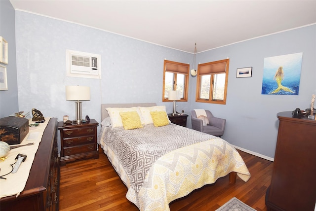 bedroom with a wall mounted air conditioner, crown molding, and wood finished floors