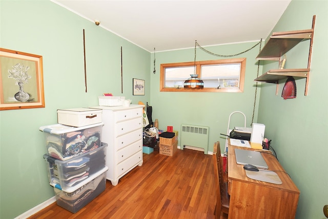 office with baseboards, wood finished floors, and radiator heating unit