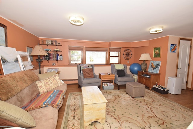 living area with a baseboard heating unit and wood finished floors