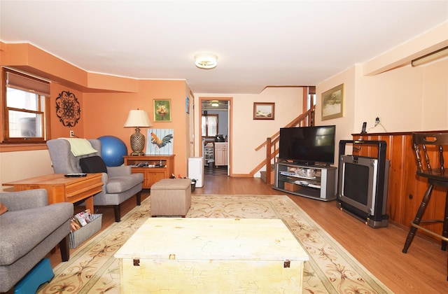 living room with stairway and wood finished floors