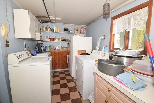 laundry area with cabinet space, light floors, and washer and clothes dryer