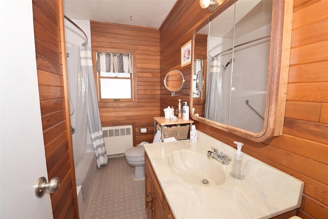 bathroom with vanity, shower / bathtub combination with curtain, radiator heating unit, wood walls, and toilet