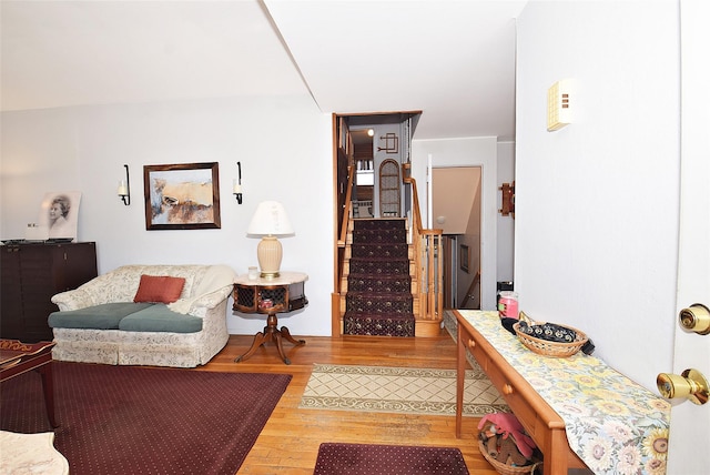 living room featuring wood finished floors and stairs