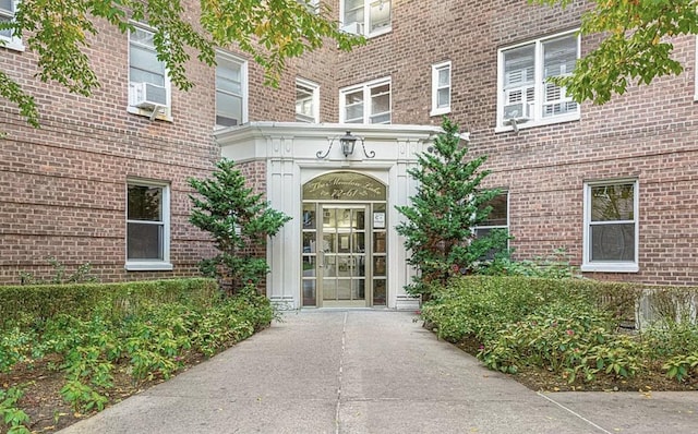 entrance to property featuring brick siding