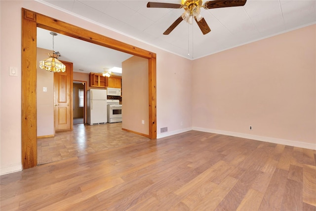 unfurnished living room with visible vents, crown molding, baseboards, light wood-type flooring, and a ceiling fan