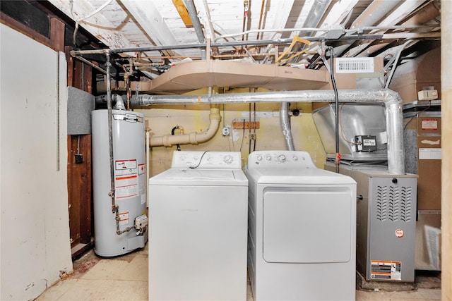 laundry room with gas water heater, visible vents, independent washer and dryer, and laundry area