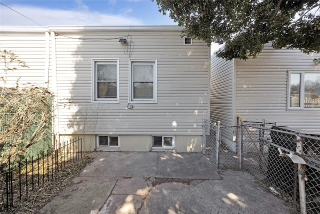 rear view of house featuring a patio and fence