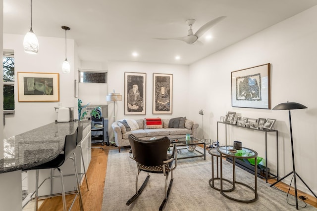 living area featuring recessed lighting, a ceiling fan, and wood finished floors