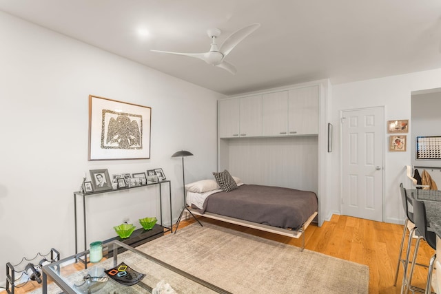 bedroom with light wood-style floors and ceiling fan