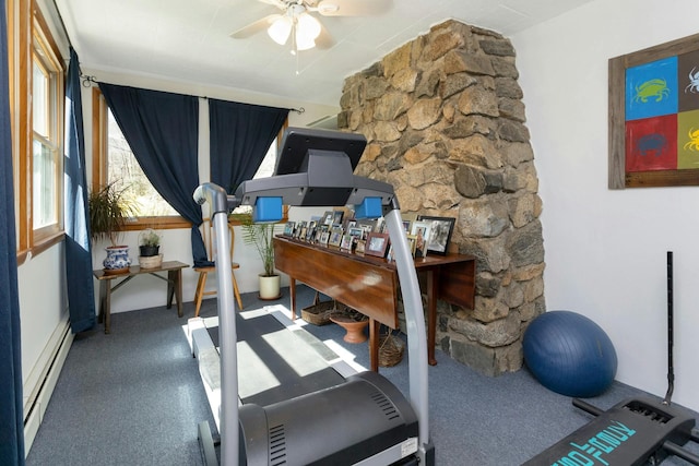 workout area featuring a ceiling fan and a baseboard radiator