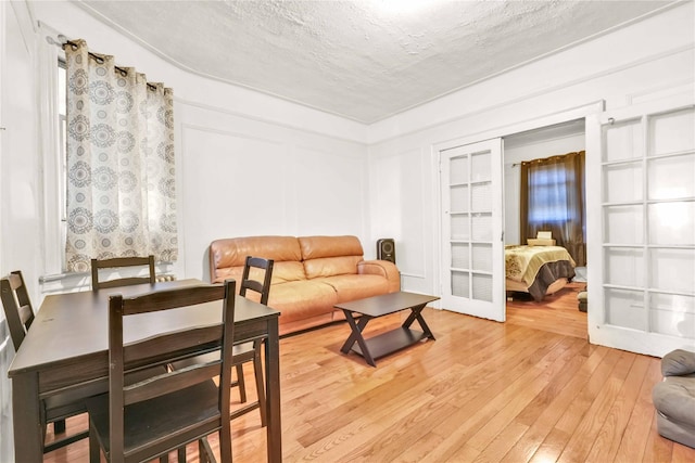 living area featuring a textured ceiling and light wood-style floors