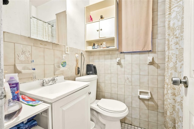 full bathroom featuring vanity, toilet, and tile walls