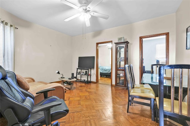 sitting room with plenty of natural light and a ceiling fan