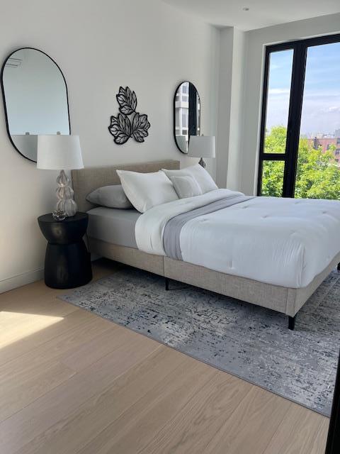 108-15 72nd Ave Unit 5D, Forest Hills, NY 11375 - bedroom with baseboards and wood finished floors