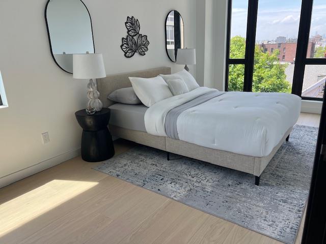 108-15 72nd Ave Unit 5D, Forest Hills, NY 11375 - bedroom featuring multiple windows and wood finished floors