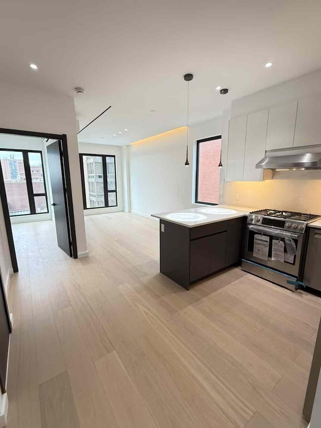 108-15 72nd Ave Unit 5A, Forest Hills, NY 11375 - kitchen with gas range, modern cabinets, a peninsula, open floor plan, and white cabinetry