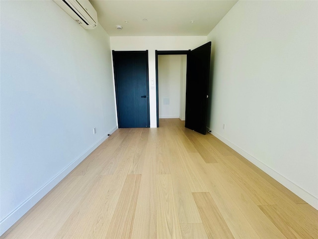 108-15 72nd Ave Unit 5A, Forest Hills, NY 11375 - unfurnished room with a wall unit AC, light wood-style floors, and baseboards