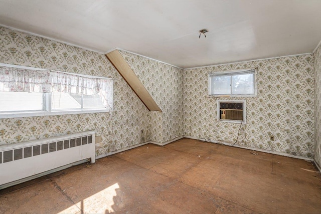 spare room featuring wallpapered walls and radiator heating unit