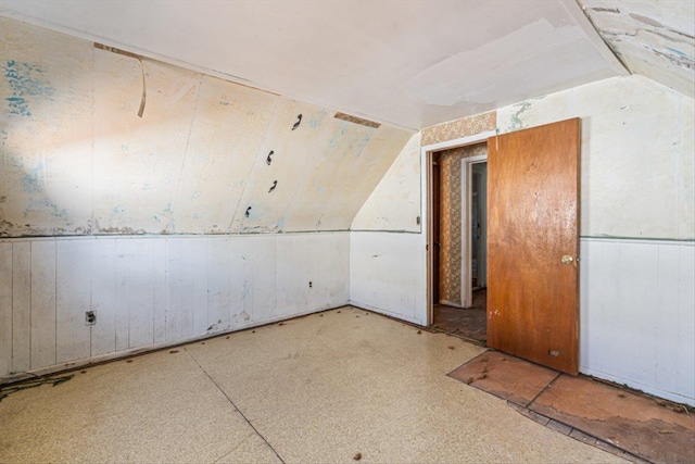 additional living space featuring vaulted ceiling