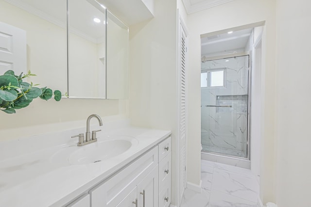 bathroom featuring marble finish floor, a marble finish shower, crown molding, baseboards, and vanity