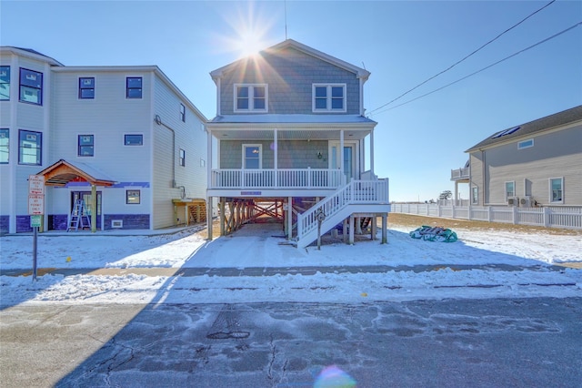 view of front of house featuring stairs, a porch, and a carport