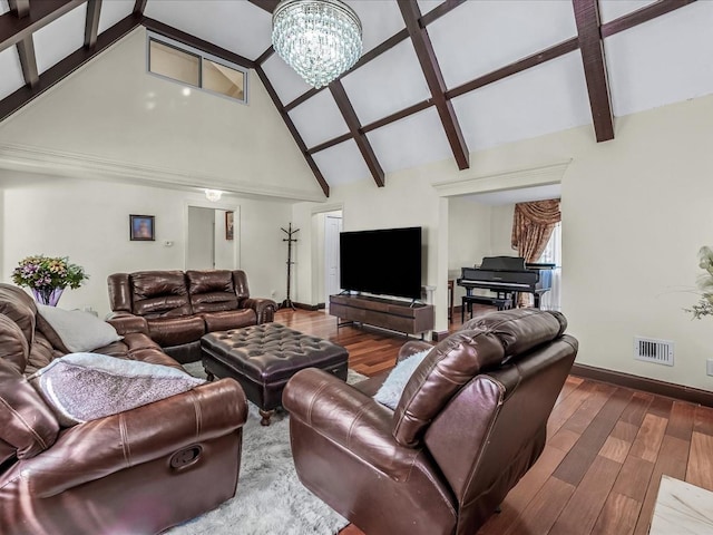 living area featuring visible vents, beam ceiling, a notable chandelier, and wood finished floors