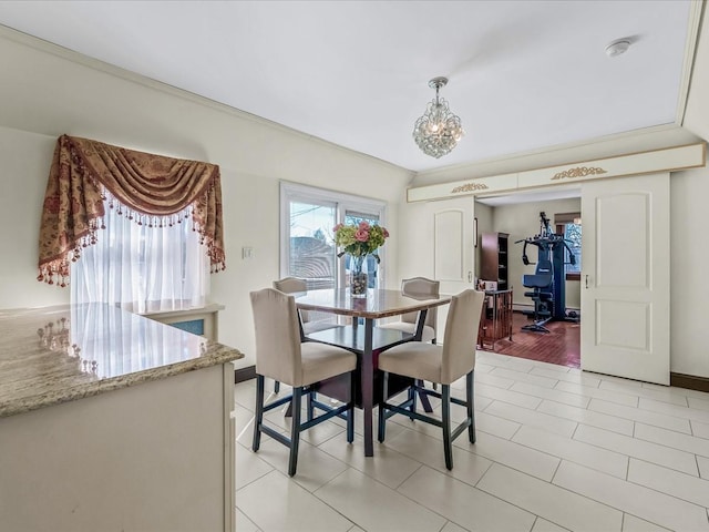 dining room featuring baseboards and a notable chandelier