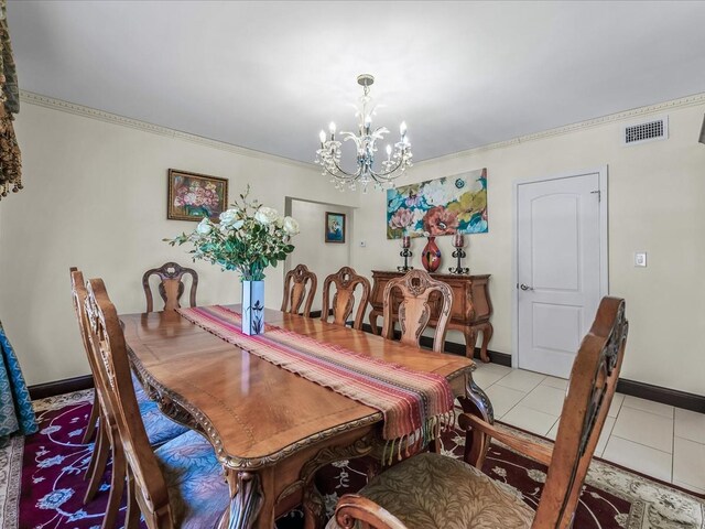 dining room with light tile patterned floors, visible vents, an inviting chandelier, and ornamental molding