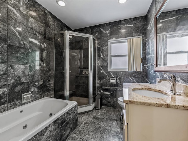 bathroom featuring vanity, tile walls, a jetted tub, and a shower stall