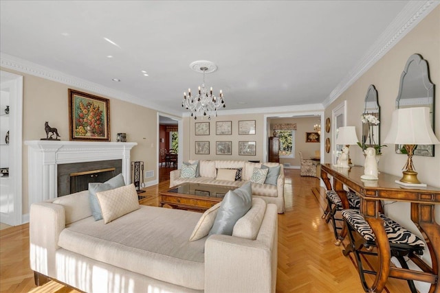 living room with ornamental molding, baseboards, an inviting chandelier, and a fireplace