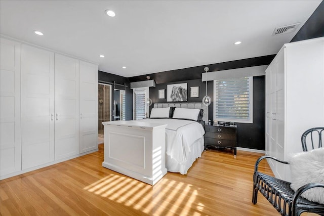 bedroom featuring visible vents, light wood finished floors, and recessed lighting