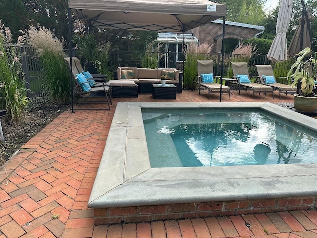 view of pool with fence, a patio, an outdoor hangout area, and a hot tub