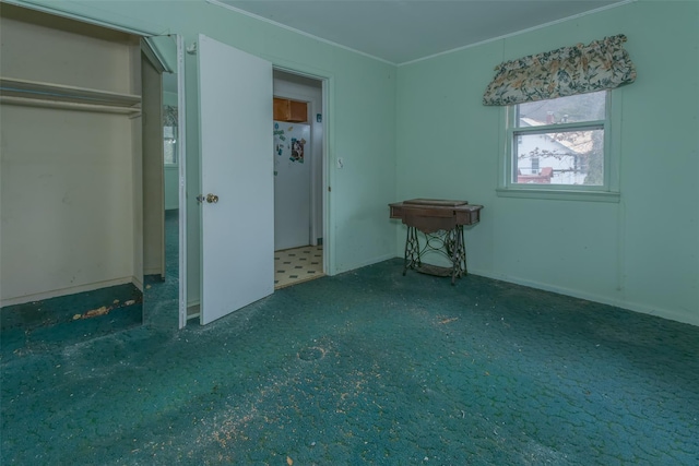 unfurnished bedroom featuring carpet flooring, crown molding, and freestanding refrigerator