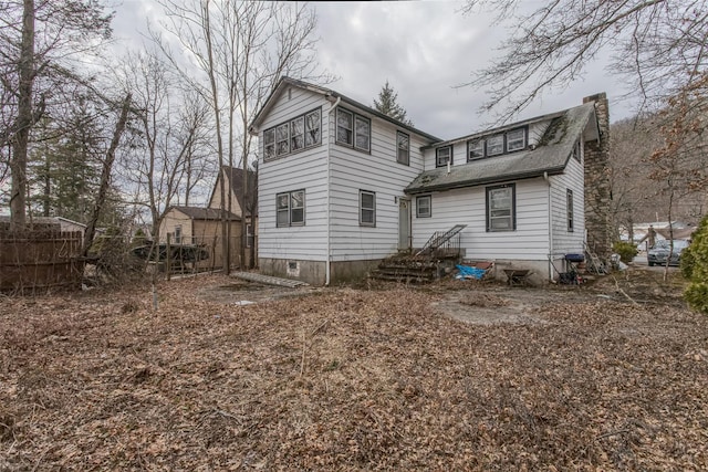 rear view of house with fence