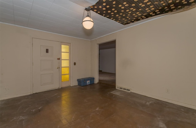 spare room featuring crown molding and visible vents