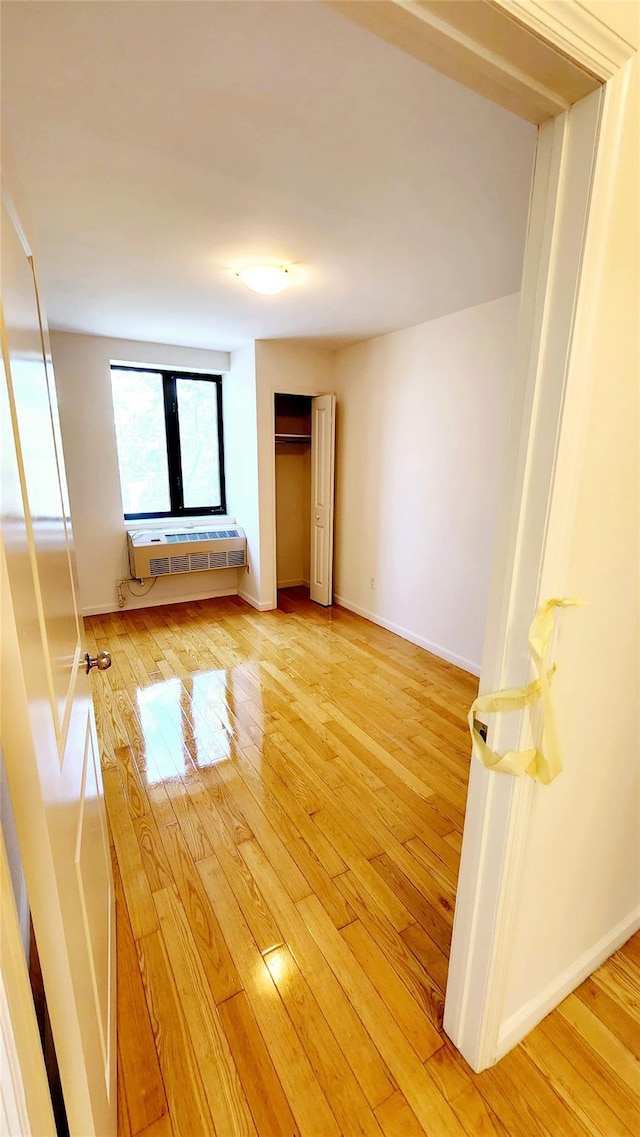 empty room with baseboards and light wood finished floors