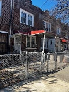 view of front facade with a fenced front yard and a gate