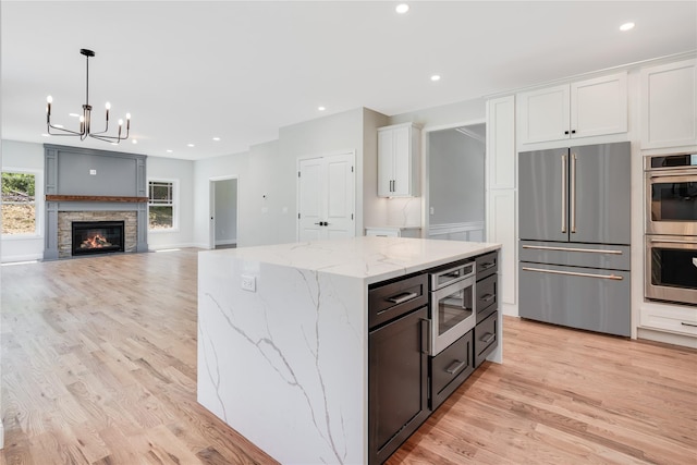 kitchen with white cabinets, recessed lighting, light wood-style flooring, and stainless steel appliances