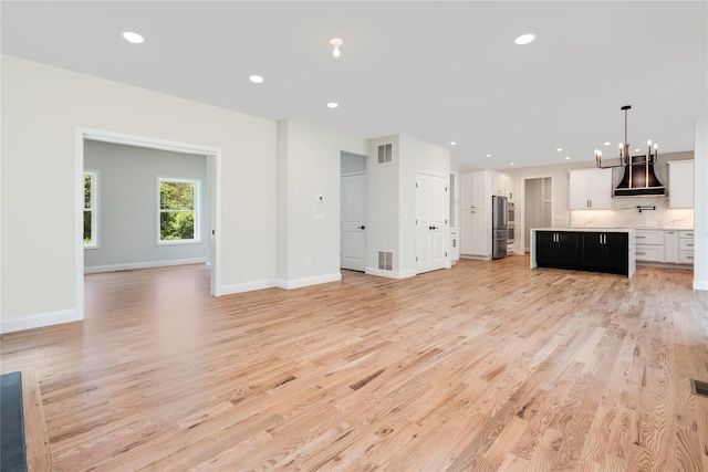 unfurnished living room featuring recessed lighting, visible vents, baseboards, and light wood-style flooring