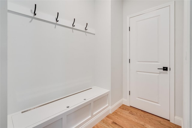 mudroom featuring baseboards and light wood finished floors