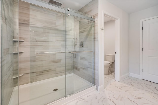 full bath with toilet, baseboards, marble finish floor, and a stall shower