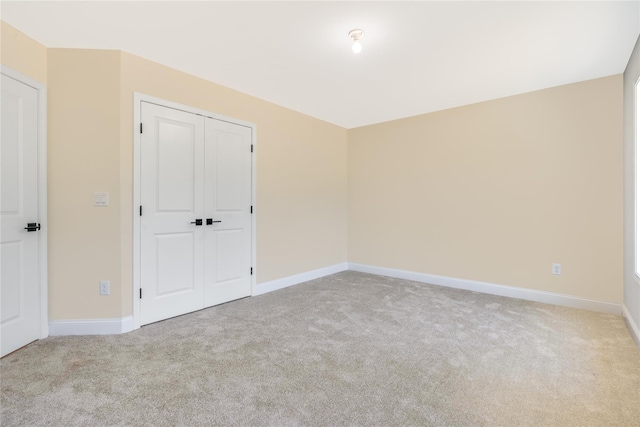 carpeted spare room with baseboards